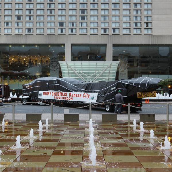 Arrival of the Mayor's Christmas Tree with shops in the background